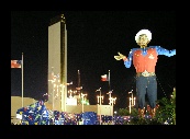 Big Tex is showing off his new shirt to everyone.